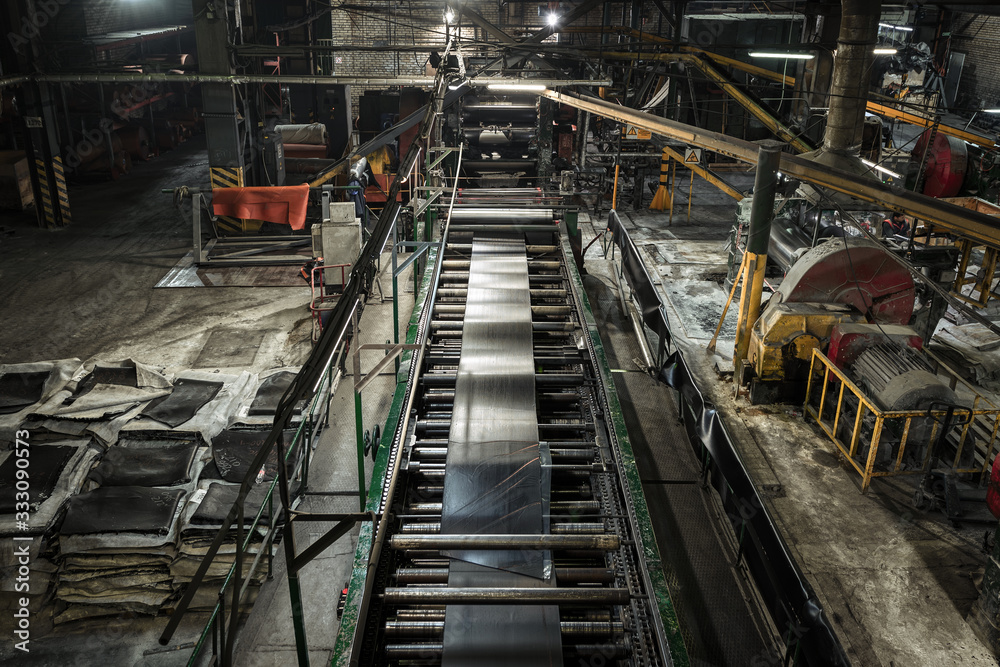 Interior of a factory for manufacturing rubber conveyor belts.