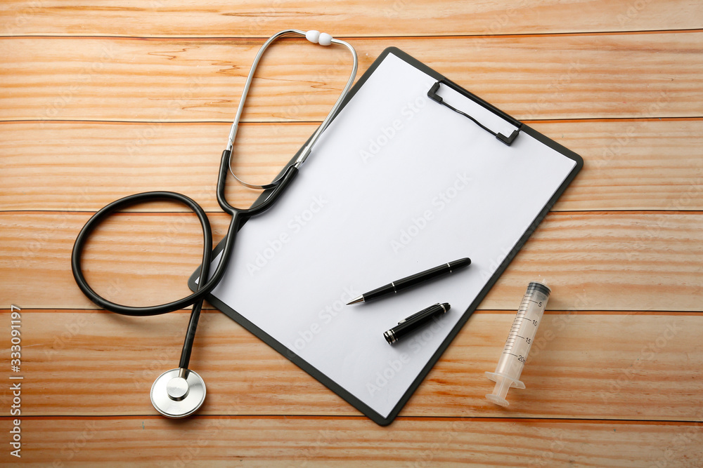 stethoscope and notebook on table stethoscope and notebook on table