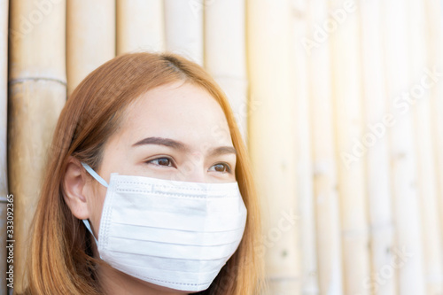 Asian woman wearing white mask. Concept of using medical mask to prevent the spread of germs, such as Corona virus COVID-19