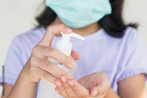 asia women wearing hygienic mask to prevent the virus PM2.5, Coronavirus, (2019-nCoV) asian little girl washing hands with alcohol gel or antibacterial soap sanitizer,virus. healthcare concept..
