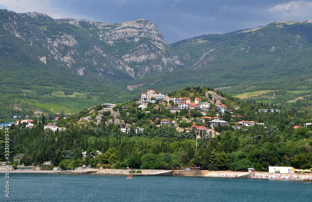 view of the small village in the green mountains near sea at summer