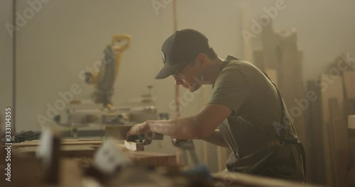 Woodworker man working in garage