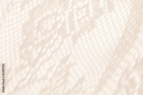 Sunlight on the wall with shadows from the white lace curtain. Spring and summer texture background photo