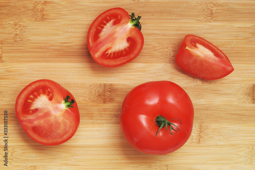 sliced fresh red tomatoes on the background of a bamboo kitchen Board sliced fresh red tomatoes on the background of a bamboo kitchen Board