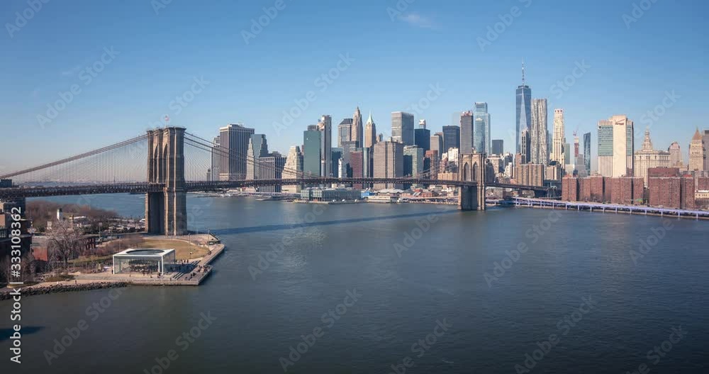 View of Manhattan Downtown and Brooklyn bridge from the Manhattan bridge in New York City, NY, USA. Timelapse during early morning. View of Manhattan Downtown and Brooklyn bridge from the Manhattan bridge in New York City, NY, USA. Timelapse during early morning.