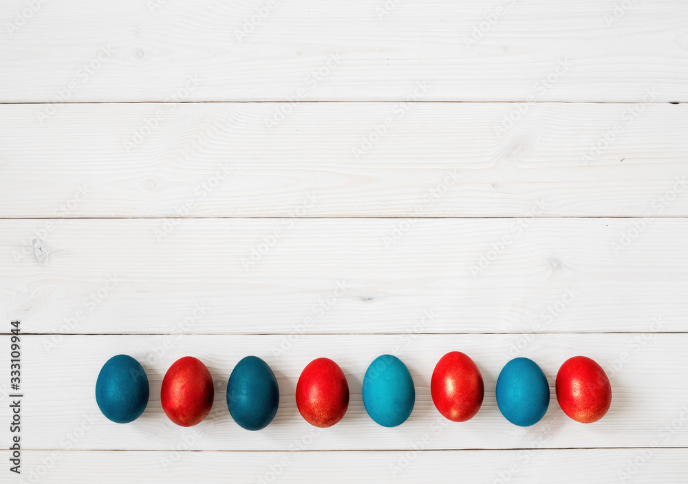 Obraz premium Easter eggs on white wooden background