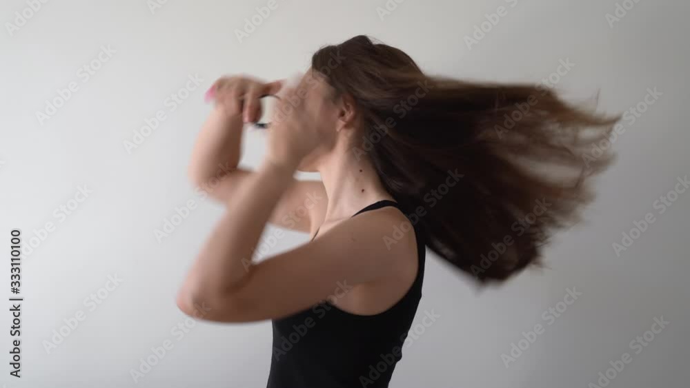 Morning routine of young caucasian woman. Combing her hair Morning routine of young caucasian woman. Combing her hair