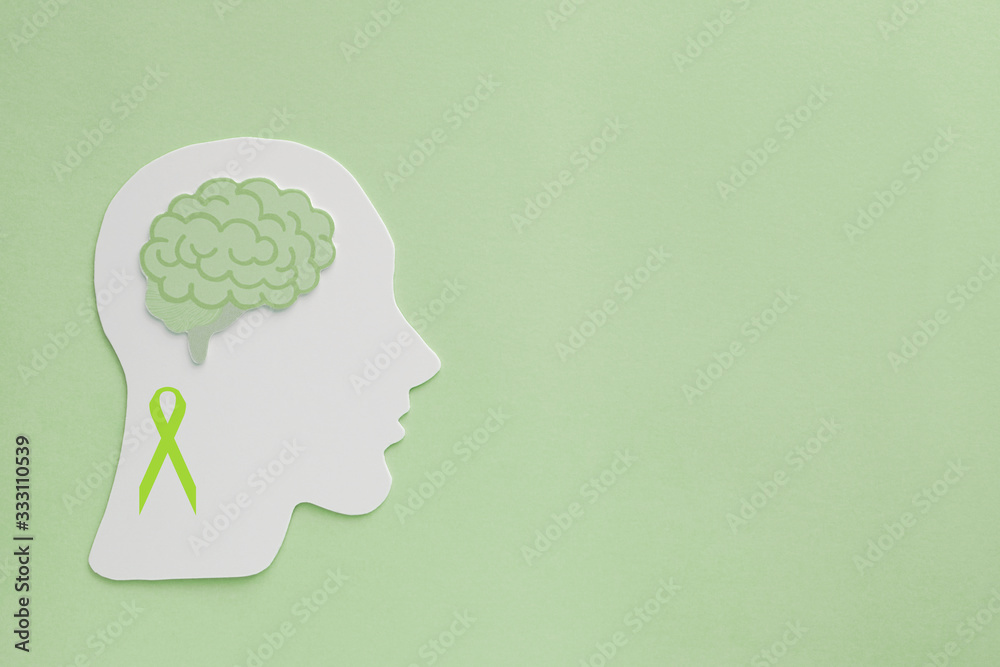 brain paper cutout on green background,