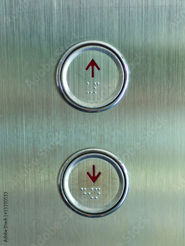 Elevator buttons panel show up and down direction and braille sign.