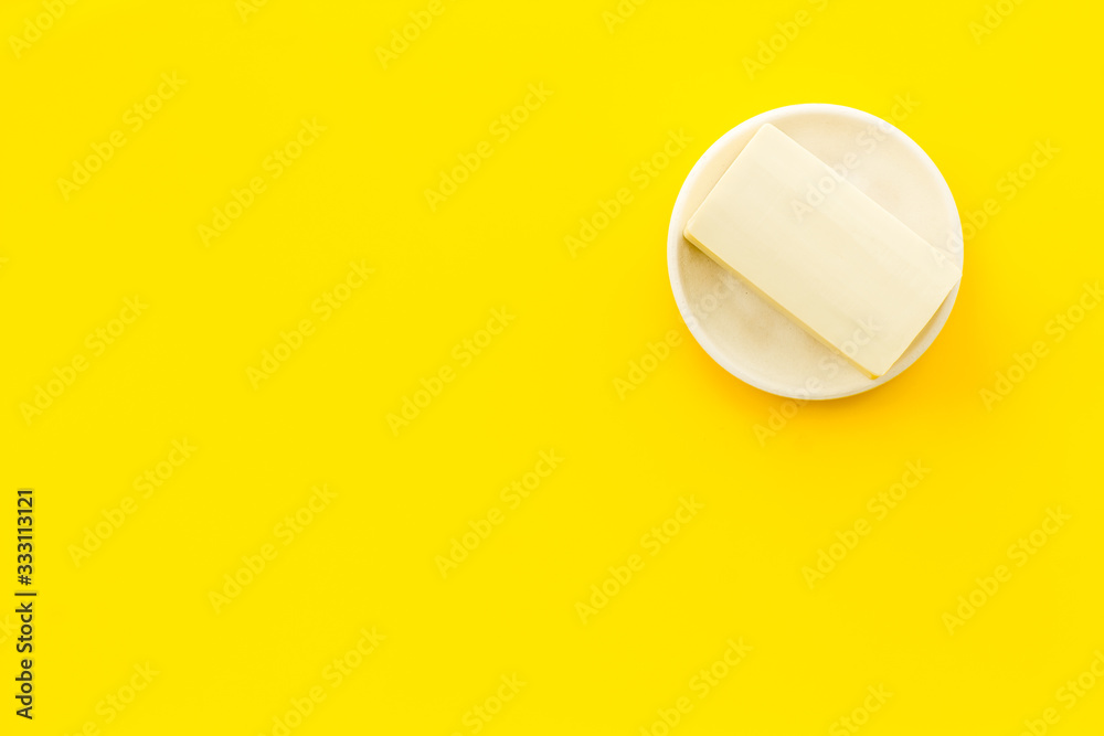 Soap bar - hygiene concept - on yellow background top-down copy space Soap bar - hygiene concept - on yellow background top-down copy space