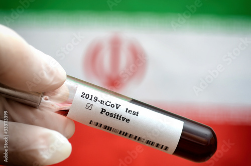 Stock photo of holding tube with Blood Test (novel Coronavirus 2019 disease,COVID-19,nCoV) and flag of Iran. Iran virus outbreak.