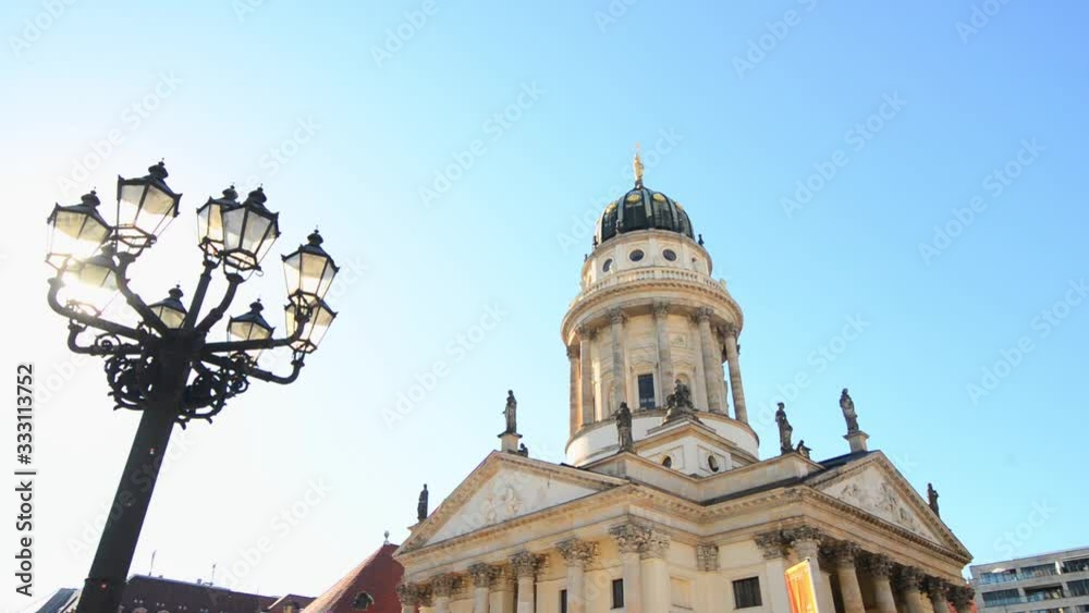 BERLIN, GERMANY - MAY 26, 2017: French Cathedrals with street light on blue sky background in sunny day