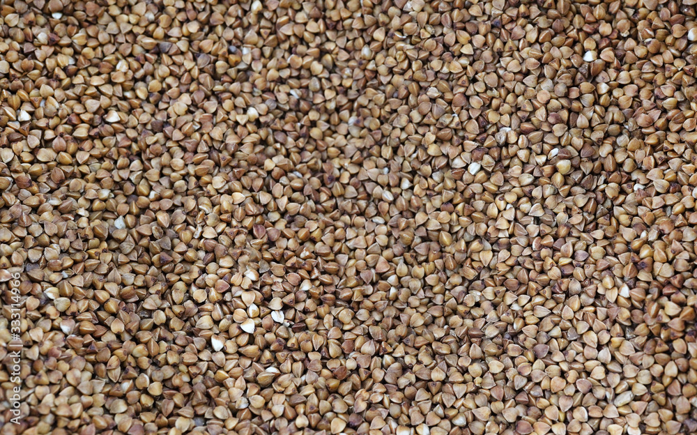 Photo food buckwheat groats. Texture background grain buckwheat groats. Image food product porridge buckwheat Photo food buckwheat groats. Texture background grain buckwheat groats. Image food product porridge buckwheat