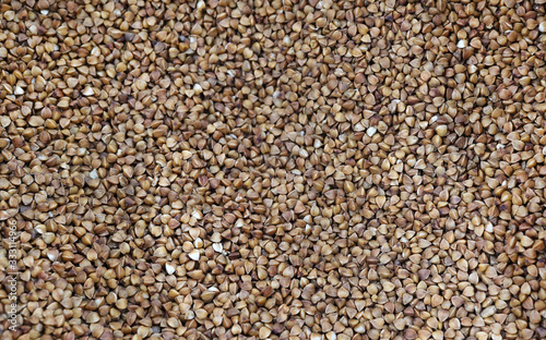 Photo food buckwheat groats. Texture background grain buckwheat groats. Image food product porridge buckwheat photo