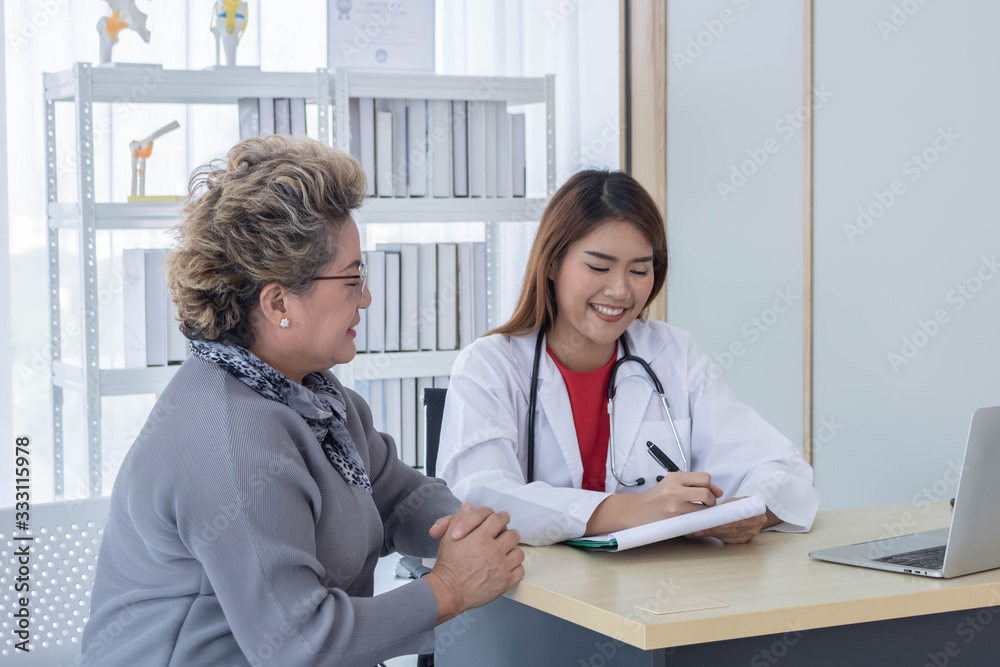 Asian doctor working in the office and discussing to the patient about her symptoms, healtcare and hospital concept. Asian doctor working in the office and discussing to the patient about her symptoms, healtcare and hospital concept.