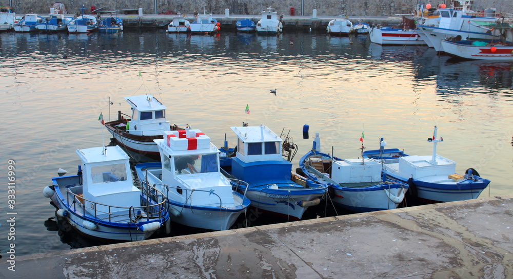 evocative image of fishing boats in port