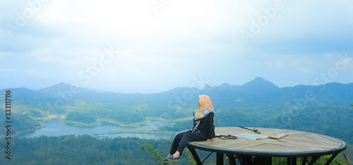 A hijab woman holiday at Kalibiru, Kulon Progo, Yogyakarta photo