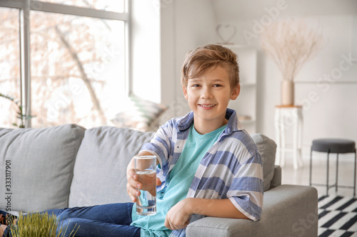 Cute little boy drinking wa...