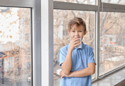 Cute little boy drinking wa...