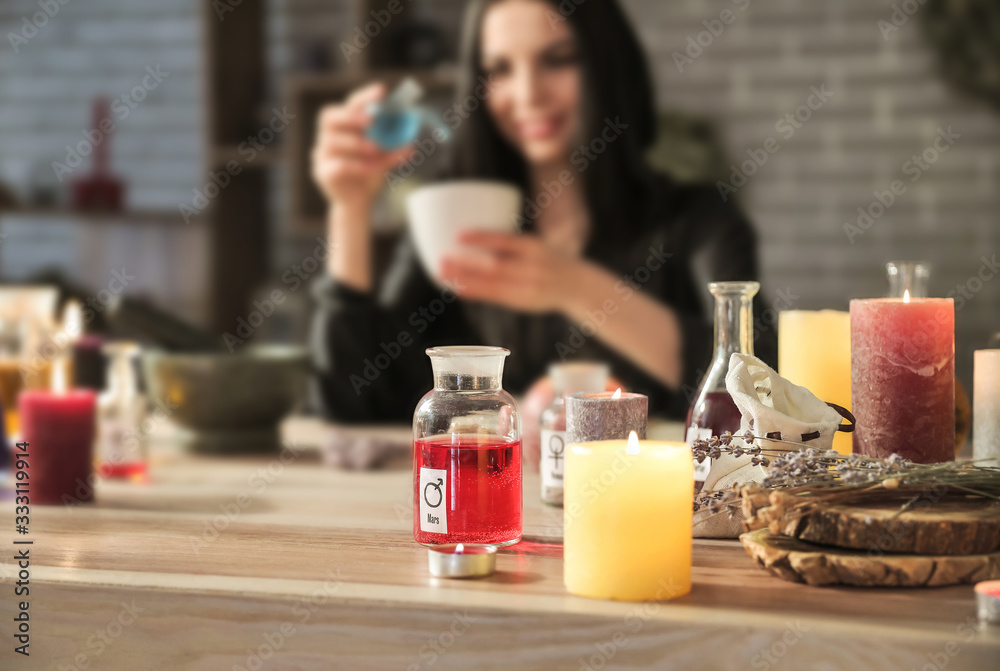 Female alchemist making elixir in laboratory Female alchemist making elixir in laboratory