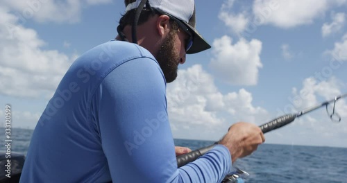 Men Fishing on boat at sea during sunny day