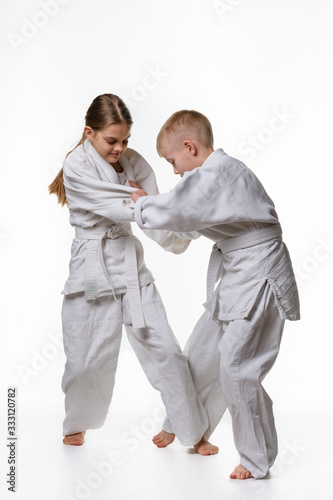 Boy and girl fight and try to make each other's cuts photo