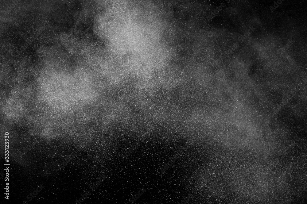 White powder explosion on black background. Abstract white dust texture.