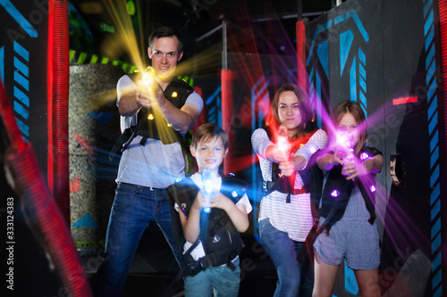 Parents and children playing laser tag in beams