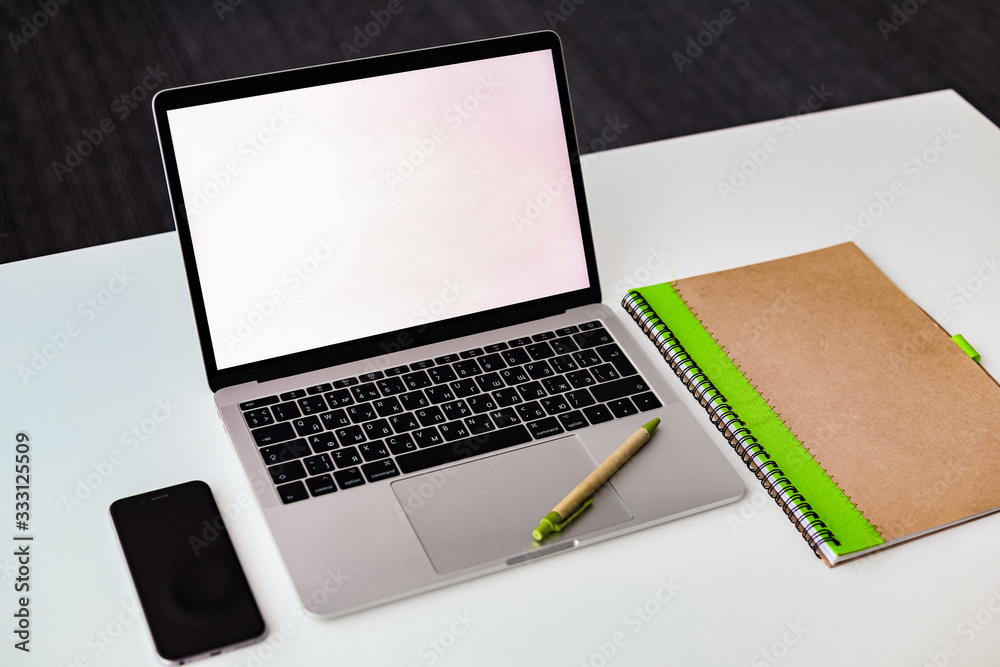 notebook, laptop and phone on the desk notebook, laptop and phone on the desk
