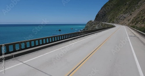 Flying along Pacific Coast Highway at Big Sur, California. Drone flying over Limekiln Creek Bridge on California's Pacific Coast Hwy at Big Sur.
