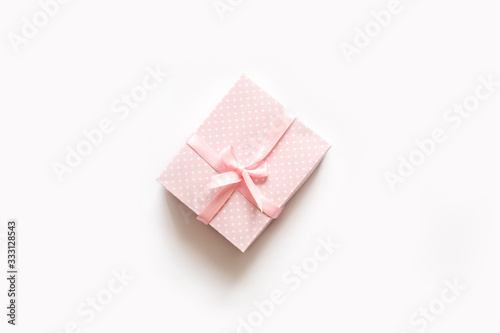 Pink gift box on white top view.