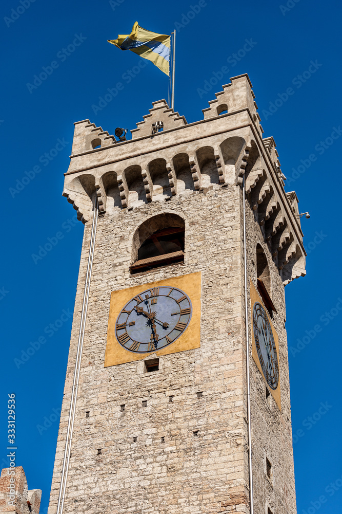 Torre Civica, Medieval civic clock tower with the city flag in Piazza del Duomo (Cathedral square), Trento downtown, Trentino-Alto Adige, Italy, Europe
