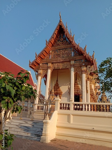 Church of Buddhist temple isolated on blue sky background closeup. Is a place religious ceremonies for Thailand people culture.