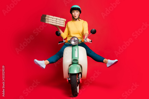 Portrait of her she nice attractive girlish cheerful cheery girl riding moped without legs having fun carrying dessert package isolated on bright vivid shine vibrant red color background