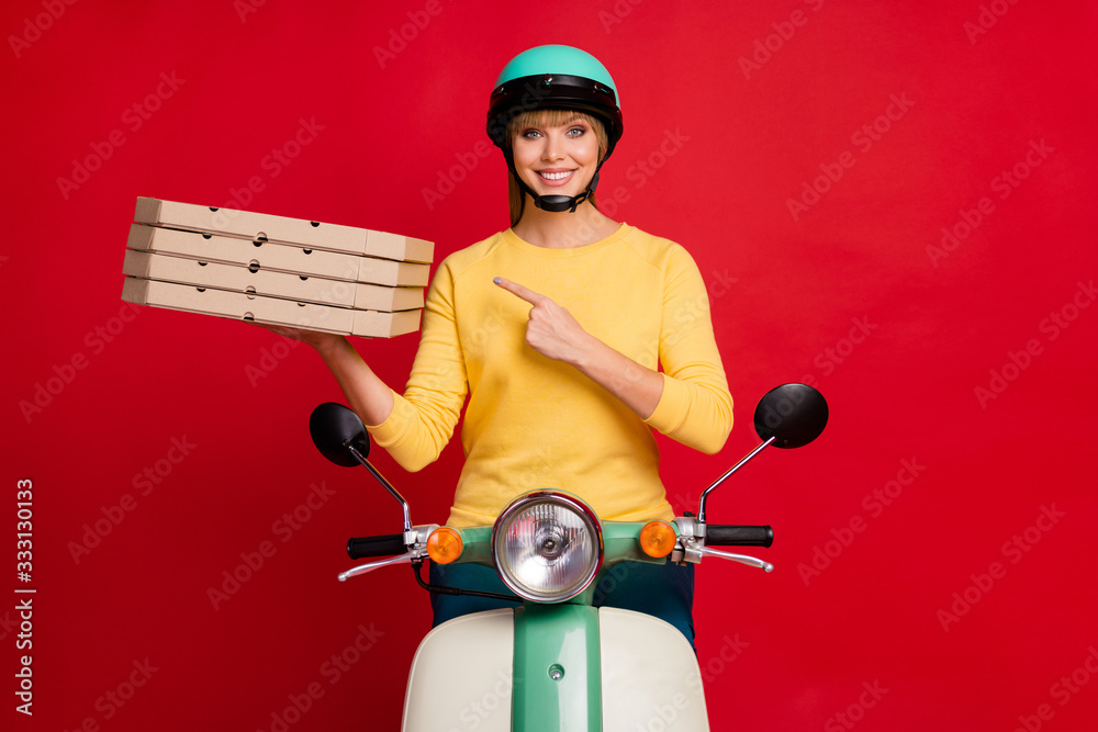 Portrait of her she nice attractive lovely confident cheerful cheery girl sitting on moped demonstrating pile stack baked pie isolated on bright vivid shine vibrant red color background