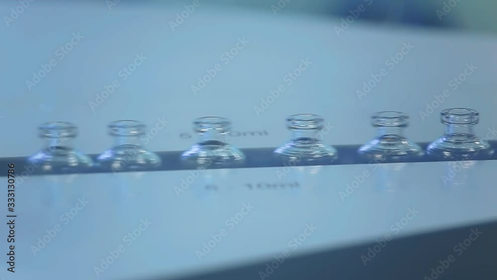 Automated tape for creating packaging and filling vials and bottles with medical medicines for the treatment of patients. Health care, medicine, coronovirus. Automated tape for creating packaging and filling vials and bottles with medical medicines for the treatment of patients. Health care, medicine, coronovirus.