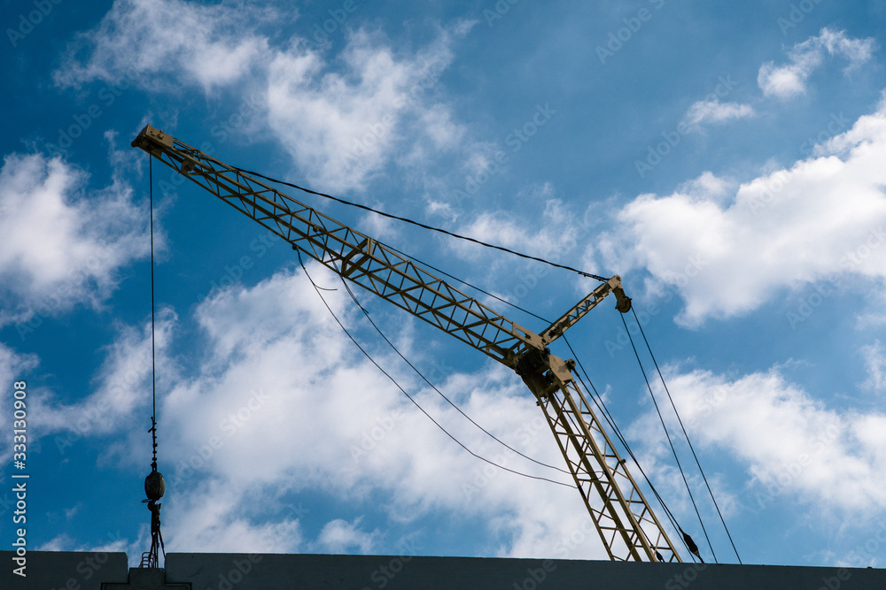 construction site with cranes on blue sky background