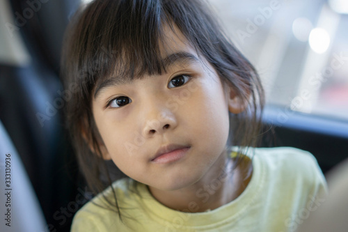 Portrait Asian cute child girl Yellow shirt in the car
