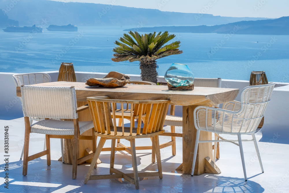 Wooden Table and Chairs on a Sun Terrace with Sea and Cruise Ships Views