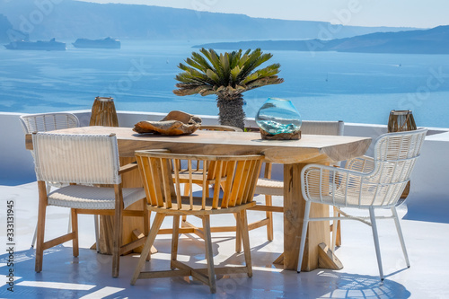 Wooden Table and Chairs on a Sun Terrace with Sea and Cruise Ships Views