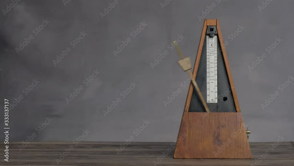 Vintage metronome shot keeping tempo in a seamless loop.