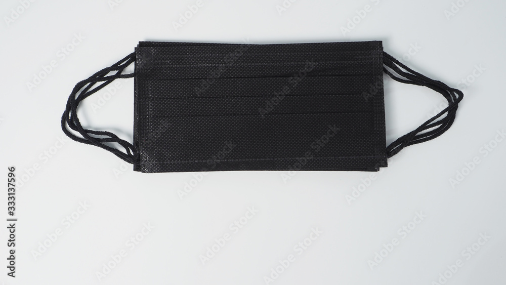 Group of black Disposable Ear- loop face mask on white background. Group of black Disposable Ear- loop face mask on white background.