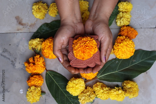 Swastika made using Marigold flowers for Ugadi with Clay Oil Lamp photo