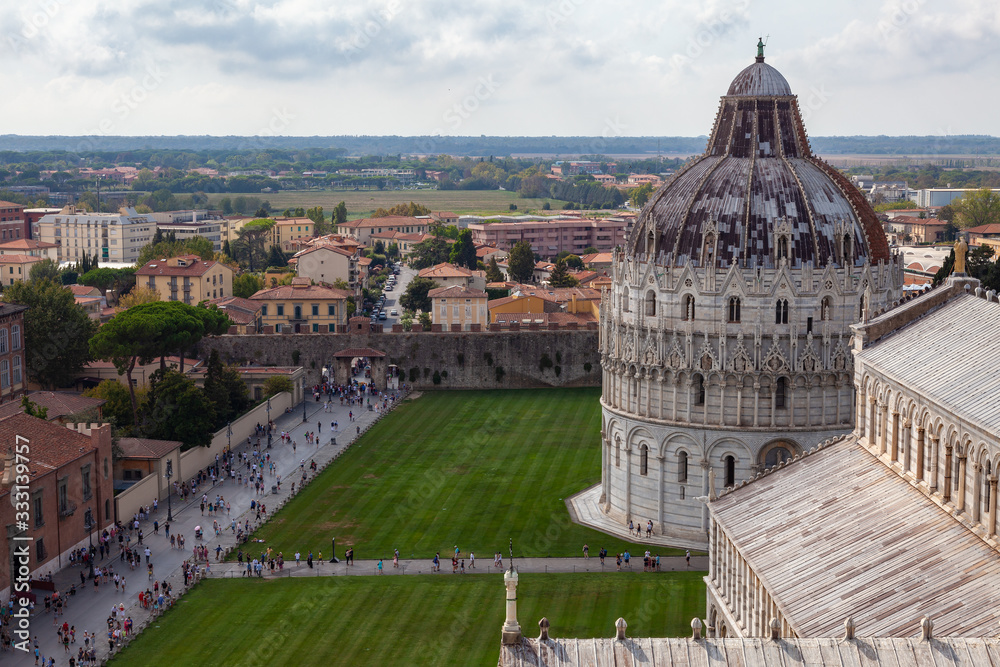 Tourists walk near the Pisa Cathedral in the city of Pisa (Italy)