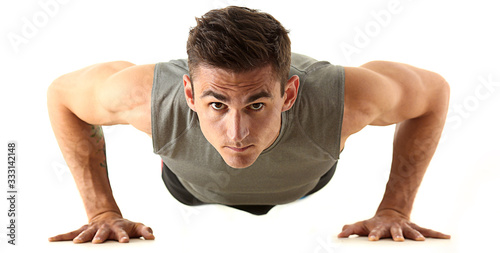 Obraz na płótnie Fitness man wringing from the floor demonstrates good physical exercises isolate