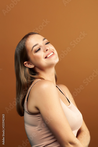 young pretty blond woman with fresh natural makeup posing cheerful on browm background, lifestyle people concept