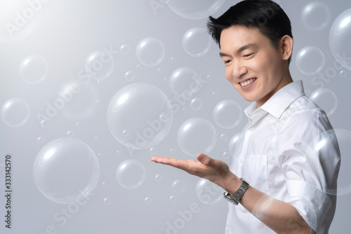 asian healthy male smile freshness white shirt show clean hand from germ and corona covid-19 viruswith bubble flote concept alway wash hand protect spread infection from covid-19 epidemic outbreak 