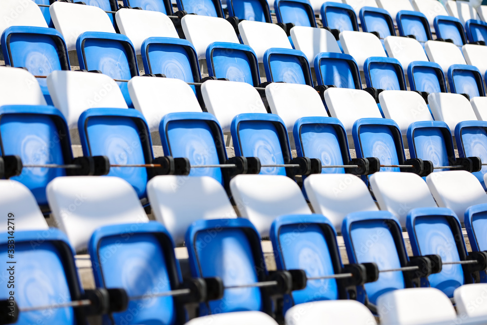 Empty tribunes in swimming pool. Modern plastic colored seats before the competition Empty tribunes in swimming pool. Modern plastic colored seats before the competition