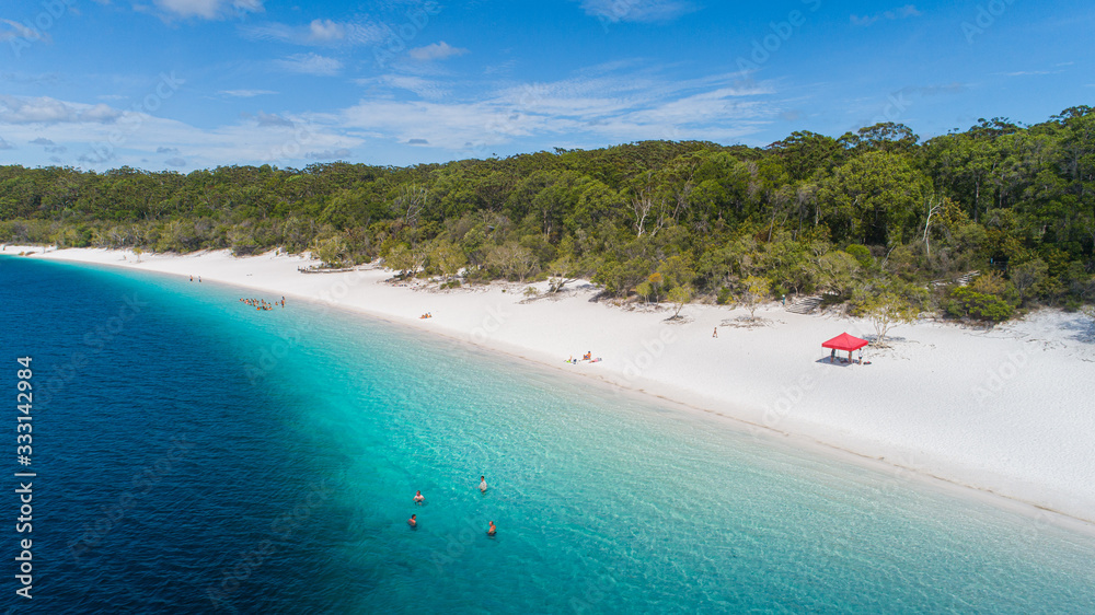Obraz premium Fraser Island, Queensland / Australia: March 2020: Tourists flock to Lake Mackenzie year round to enjoy the cool freshwater lake
