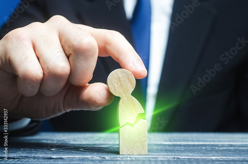 Man unites together a broken human figure. Medical healing , victory over cancer, diseases. Depression, stress, health problems. Support, recovery from crisis. Psychological rehabilitation therapy.